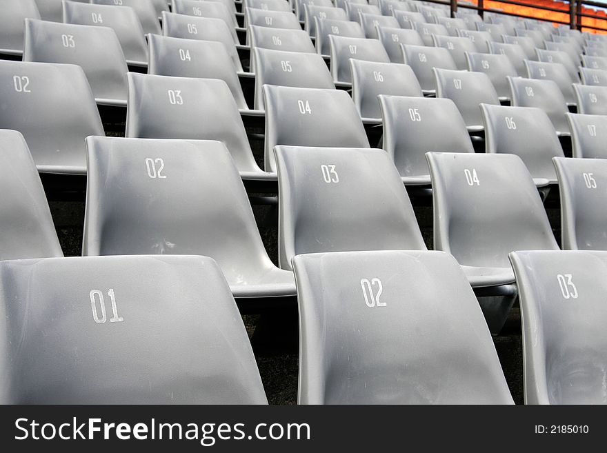 Many Empty Seats In Rows In An Outdoor Stadium. Many Empty Seats In Rows In An Outdoor Stadium