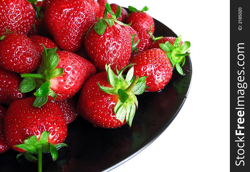 Strawberries on a black plate showing healthy living. Strawberries on a black plate showing healthy living.