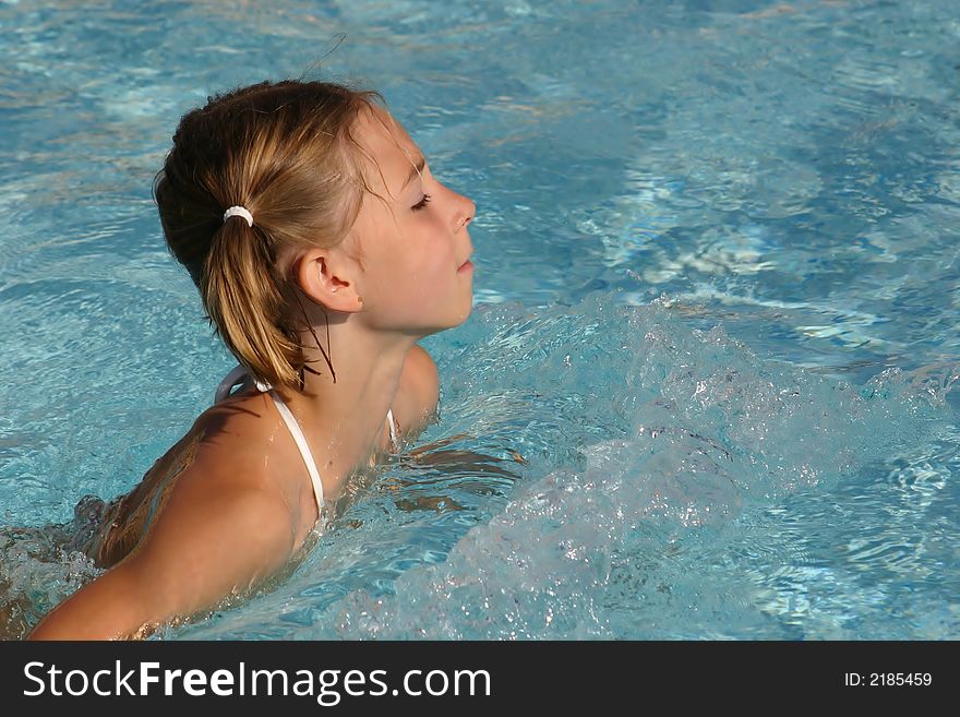 Girl swimming in the pool (copyspace on the right)