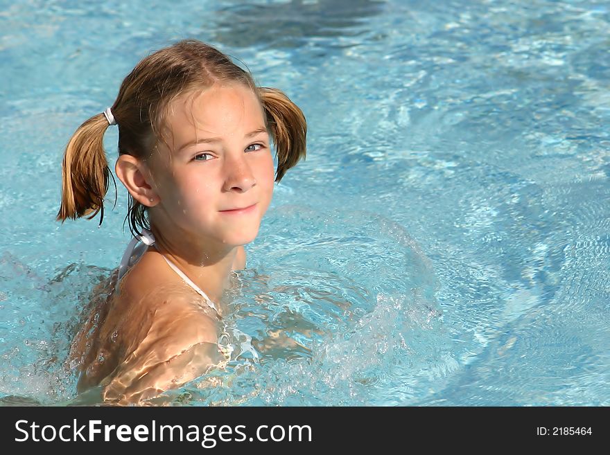 Girl swimming in the pool (copyspace on the right)