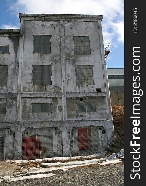 Old, grey abandoned weatherbeaten industrial building. Old, grey abandoned weatherbeaten industrial building