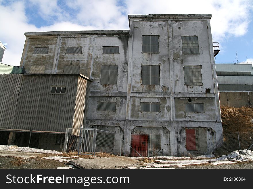 Old and grey abandoned industrial building. Old and grey abandoned industrial building