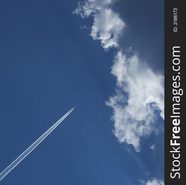 An airplane crossing the blue summer skies. An airplane crossing the blue summer skies