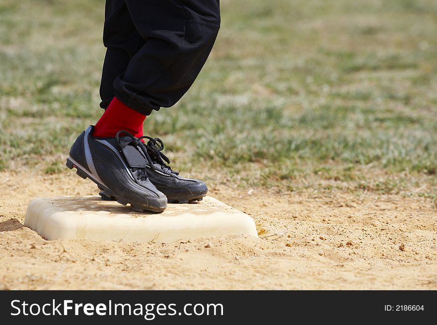 Youths feet on base during game