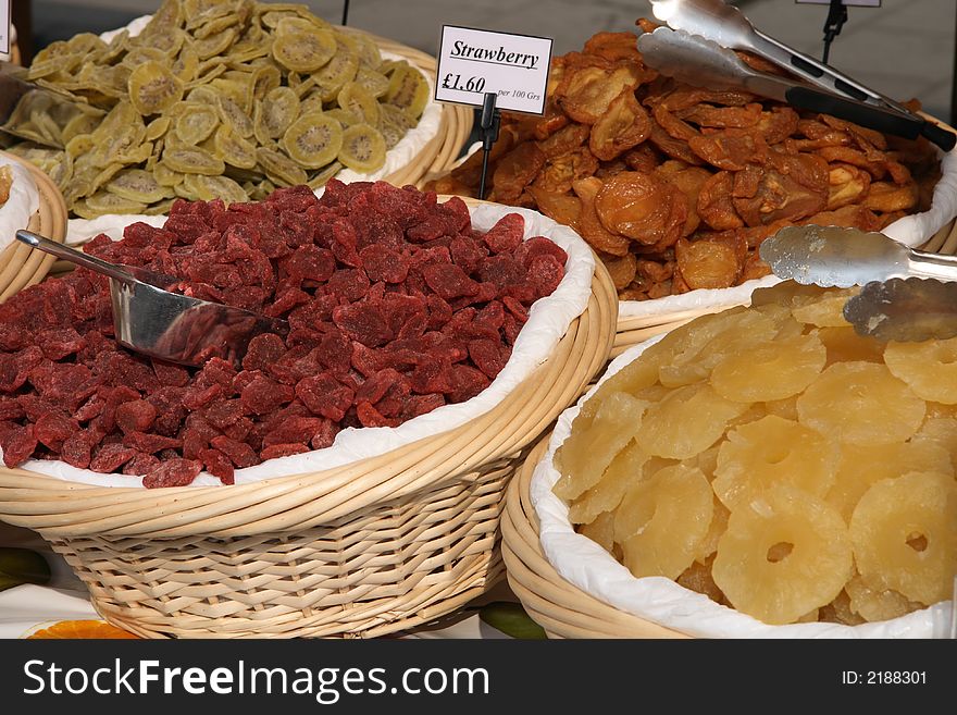 Dried strawberry, kiwi, figs and pineapple  in the market baskets. Dried strawberry, kiwi, figs and pineapple  in the market baskets