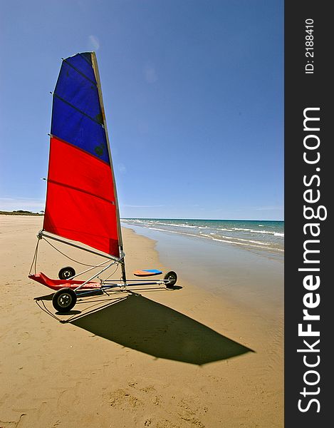 A beach yacht awaits it's driver on a magnificent tropical great barrier reef beach. The water is crystal clear, the sand is clean and the sky is blue. Combined it makes a perfect lifestyle and tropical island holiday destination. A beach yacht awaits it's driver on a magnificent tropical great barrier reef beach. The water is crystal clear, the sand is clean and the sky is blue. Combined it makes a perfect lifestyle and tropical island holiday destination.