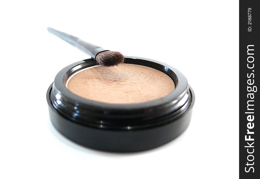 Beige natural eye shadow and brush on white background