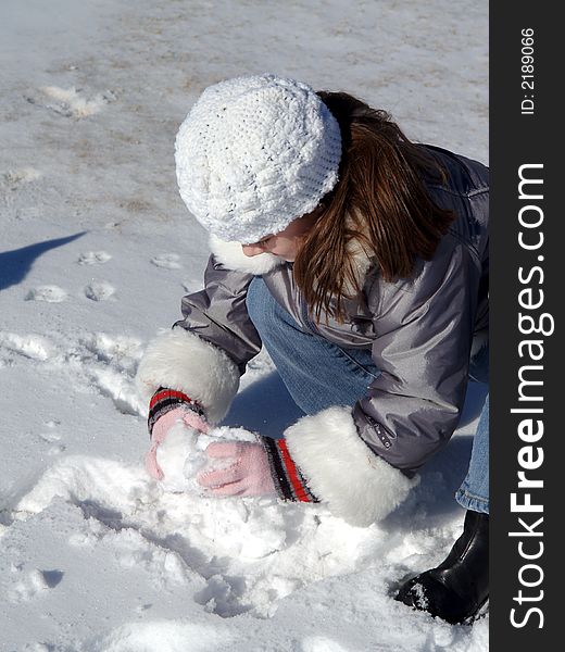 Young girl playing in the snow. Young girl playing in the snow