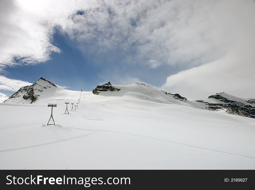 Ski slopes and a lift in the Swiss alps. Ski slopes and a lift in the Swiss alps
