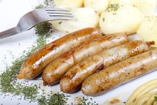 Grilled Sausages With Potatoes Stock Photos