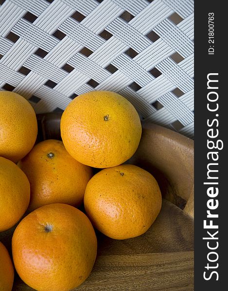 Oranges in wooden tray with white background
