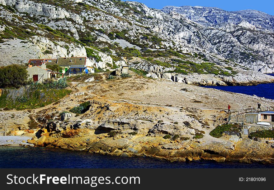 People having a walk in the calanques : steep-walled inlet, cove, or bay that is developed in limestone, dolomite and found along the Mediterranean coast.