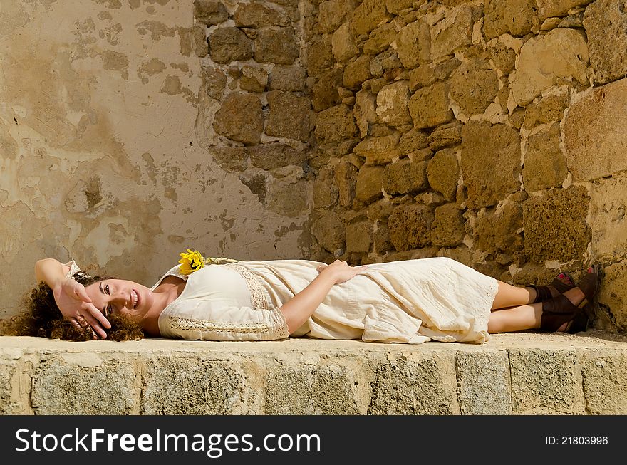 Beautiful Young Brunette Girl Lie Down On Wall