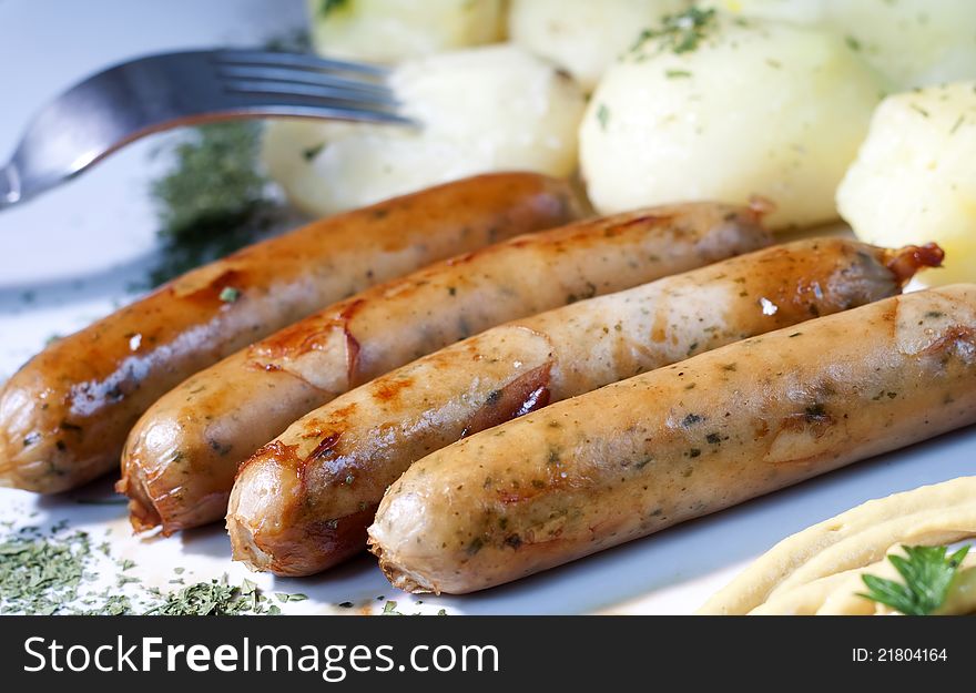 Grilled German sausages with potatoes. Grilled German sausages with potatoes