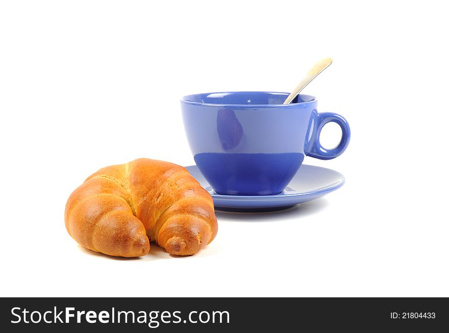 Fresh croissant with cup of tea  on a white background. Fresh croissant with cup of tea  on a white background