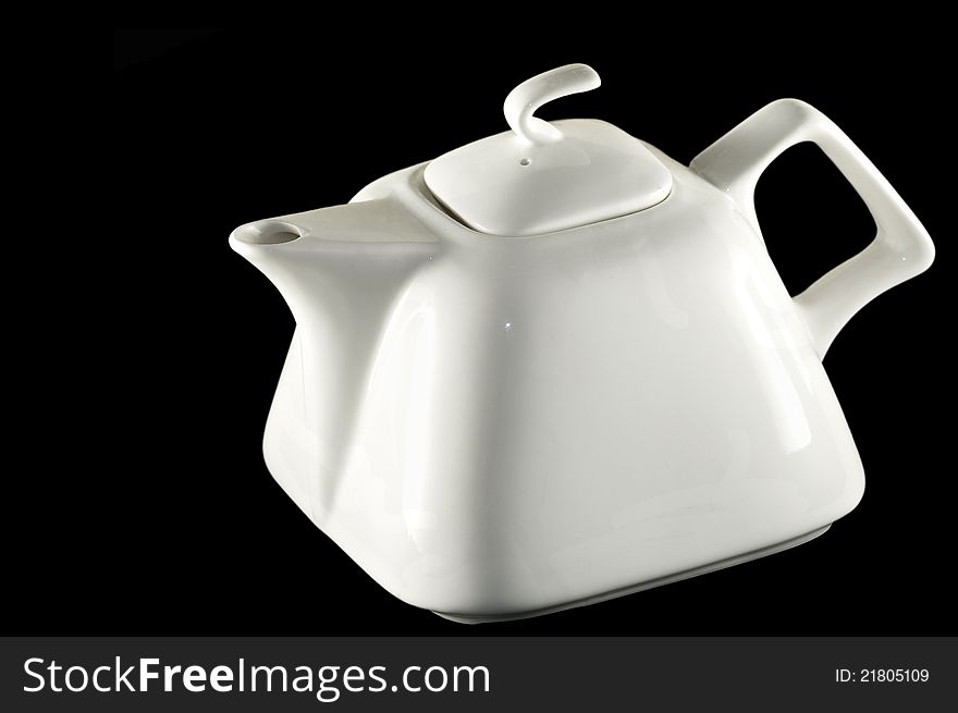 Picture of a white ceramic pitcher on black background. Picture of a white ceramic pitcher on black background
