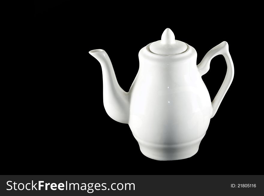 Picture of a white ceramic pitcher on black background. Picture of a white ceramic pitcher on black background
