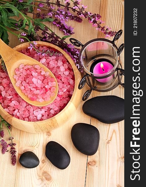 Candle, stones and salt on a wooden background. Candle, stones and salt on a wooden background