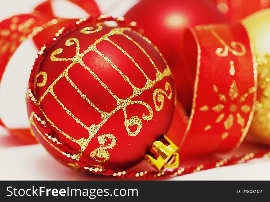 Christmas baubles with curly ribbon  on white
