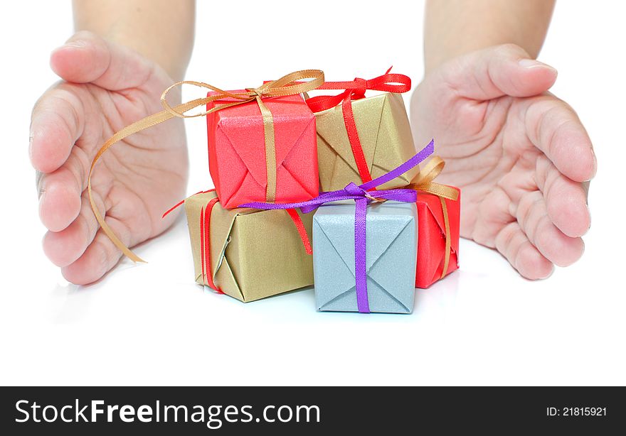 Hands presenting severall small gift boxes