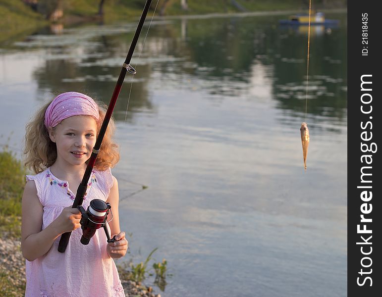 Young girl catches her first fish. Young girl catches her first fish
