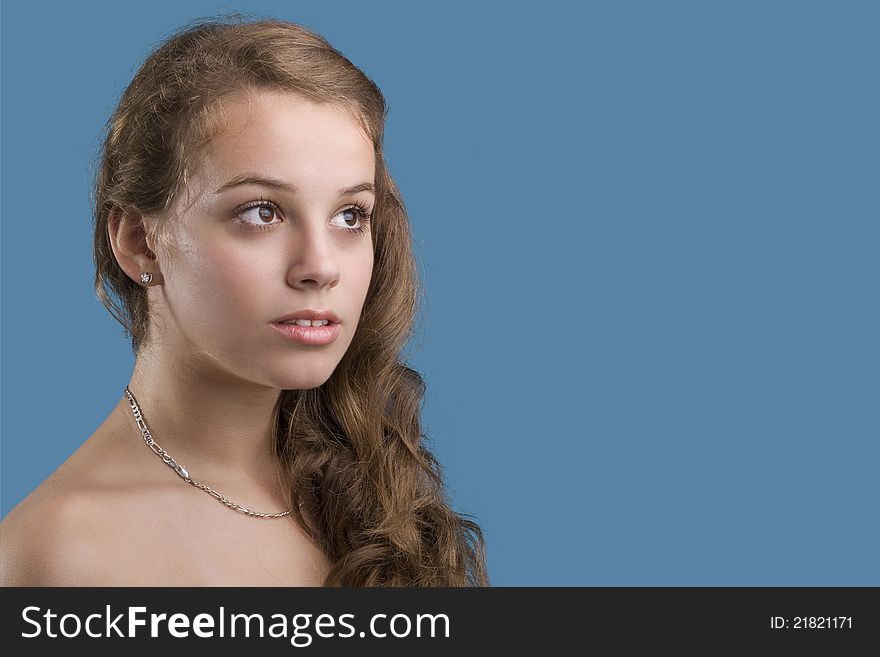 Young woman closeup portrait witb blue background