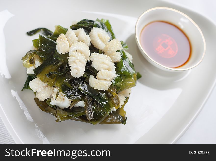 Close up shot of squid salad with sauce.