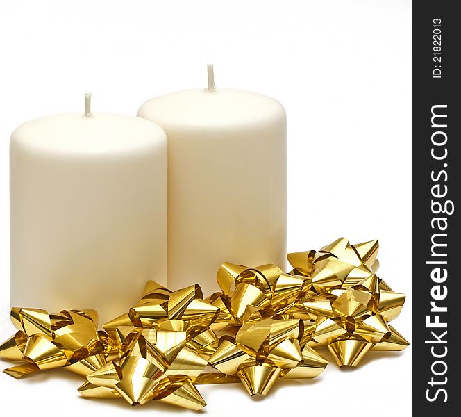 Two candles with gold bows on white background