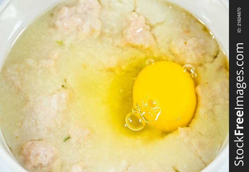 Rice porridge with pork and fresh egg