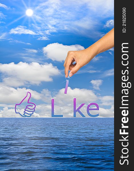 Hand putting alphabet, still sea and blue sky background, like concept