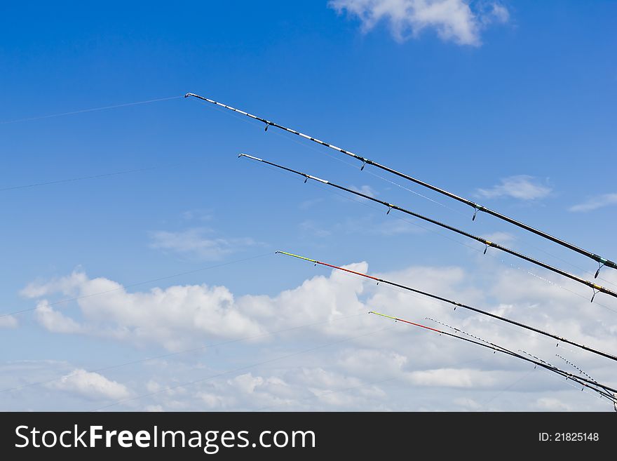 Fishing rods against blue sky