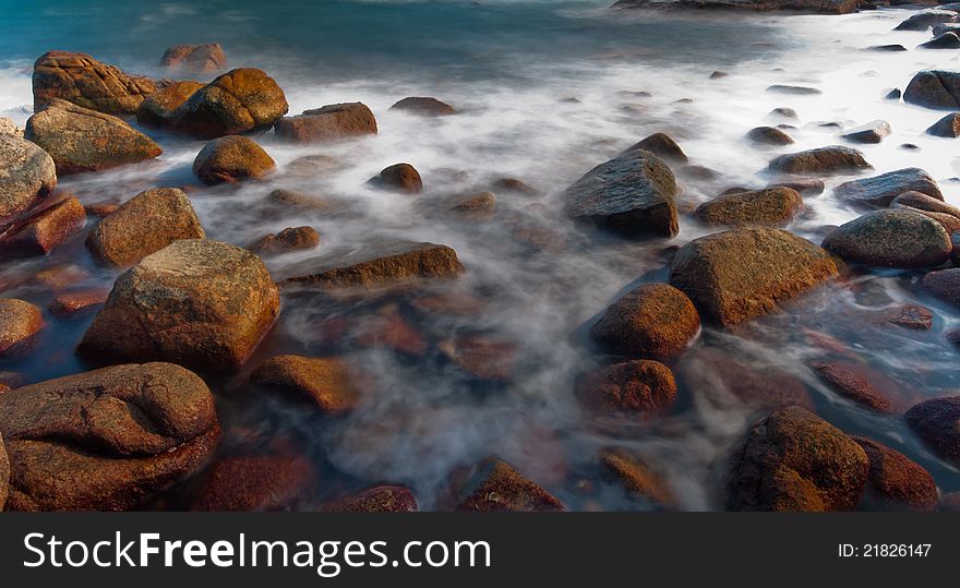 Dramatic rock in sea under long exposure