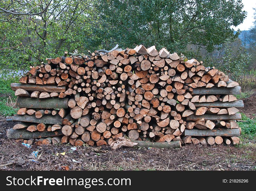 Beech wood stacked in the woodpile in the yard, for heating the furnace in the winter. Beech wood stacked in the woodpile in the yard, for heating the furnace in the winter