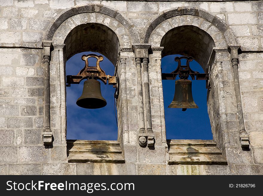 Two bells on the tower against the blue sky. Two bells on the tower against the blue sky