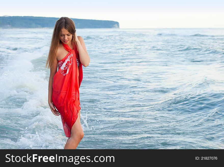 Young girl in a pareo on the sea. Young girl in a pareo on the sea