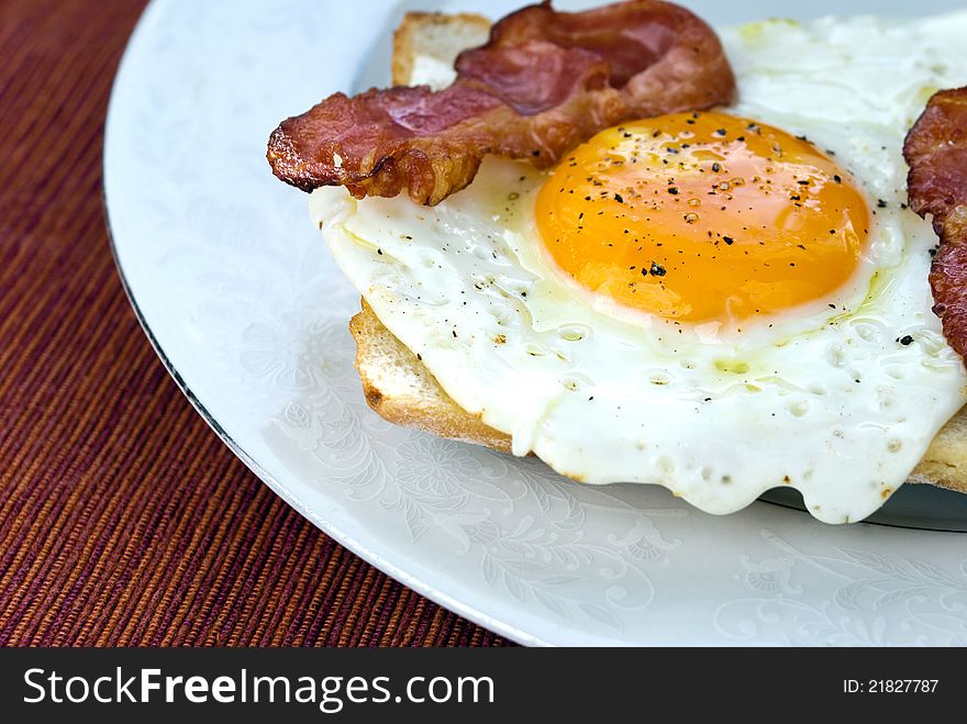 Picture of egg with bacon on fresh cibatta slice. Picture of egg with bacon on fresh cibatta slice.