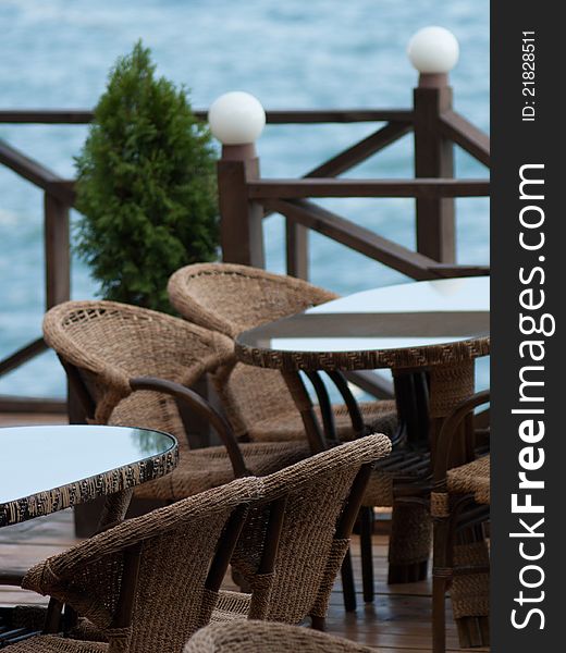 Cafe near sea with wooden chairs