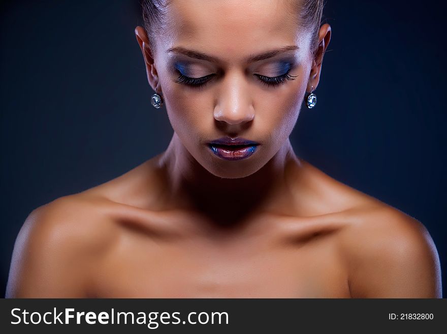 Studio portrait of attractive young woman on dark background