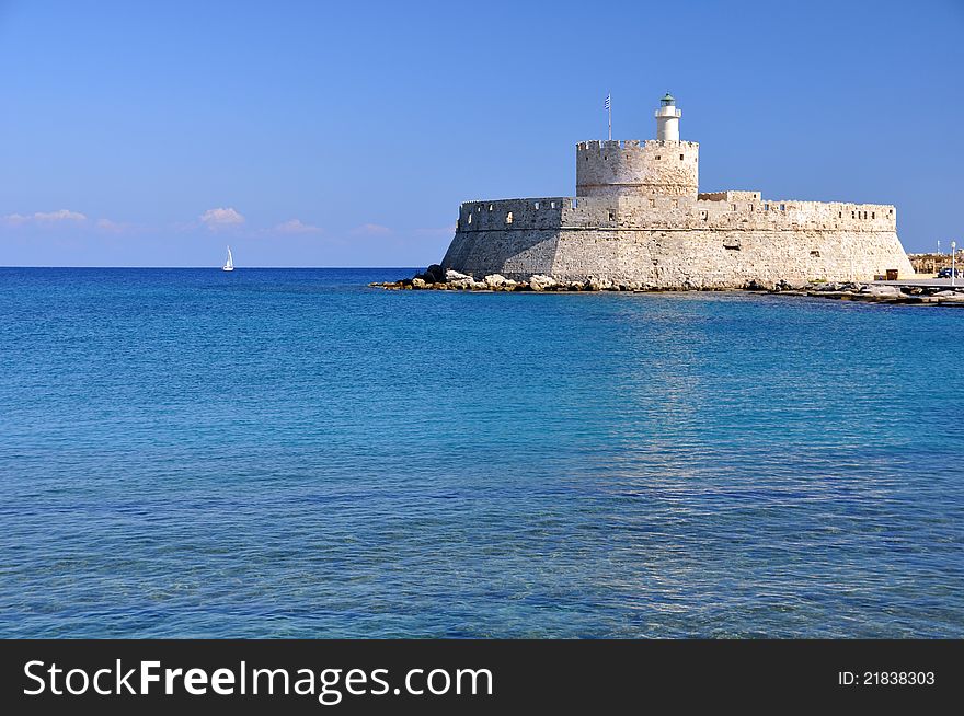 This ancient fort guards the entrance to mandraki harbour in rhodes greece. This ancient fort guards the entrance to mandraki harbour in rhodes greece