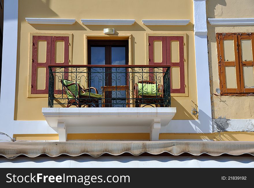 Beautiful sun drenched balcony on the greek island of symi, typical of the mediterranean region. Beautiful sun drenched balcony on the greek island of symi, typical of the mediterranean region