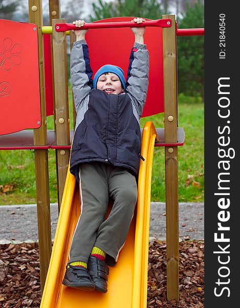 Happy smiling child in playground vertical photo