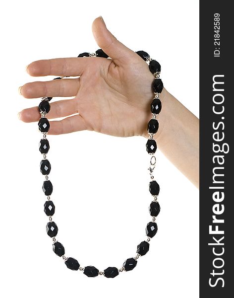 Isolated necklace of black stones in hand