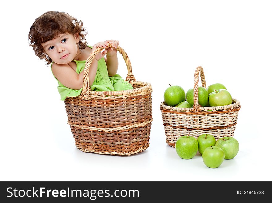 Adorable Little Girl With Green Apples In Basket