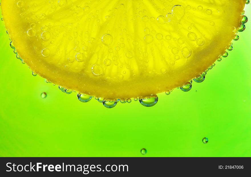 Close-up of a lemon slice with bubbles