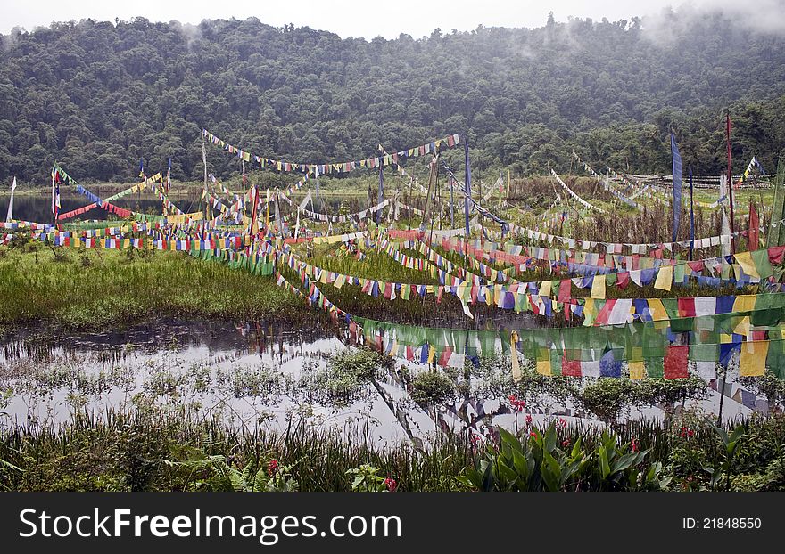 Buddhist flags at sacred lake in Sikkim, India