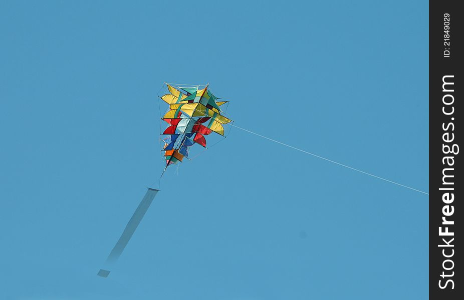 A colorful kite against a blue sky. A colorful kite against a blue sky.