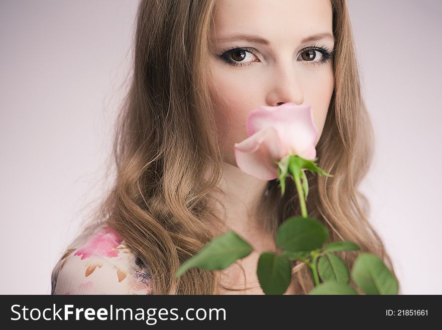 Portrait of young girl that holds delicate rose. Portrait of young girl that holds delicate rose