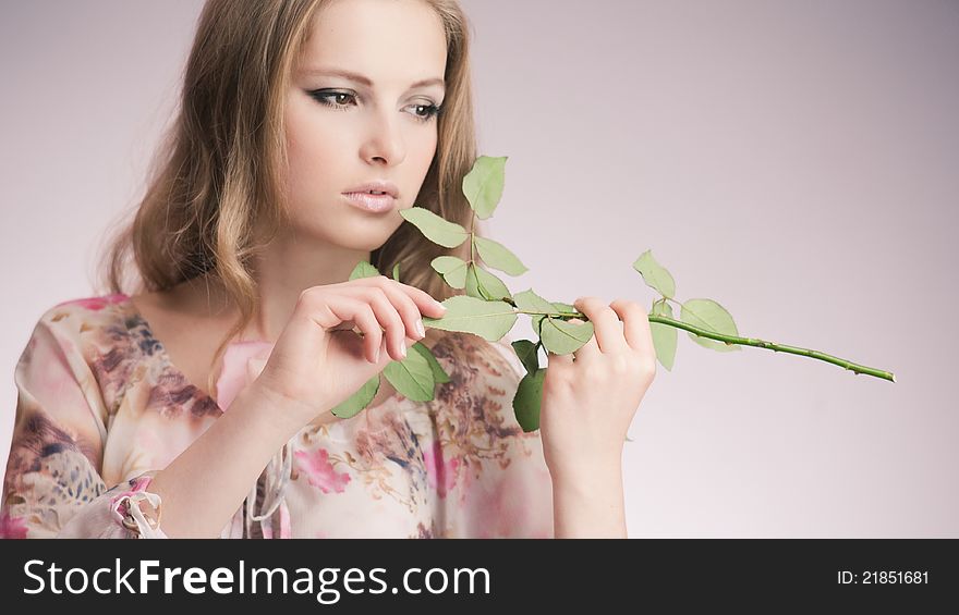 Portrait of young girl that holds delicate rose. Portrait of young girl that holds delicate rose