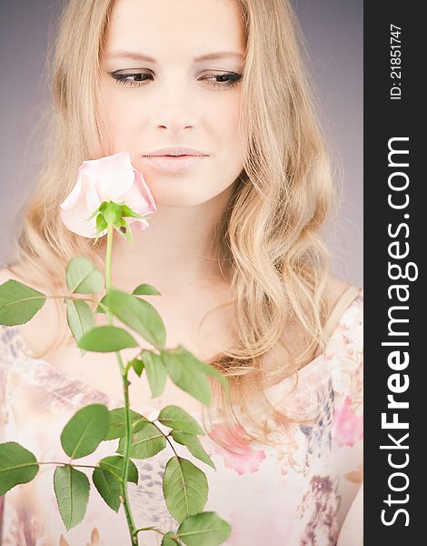 Portrait of young girl that holds delicate rose. Portrait of young girl that holds delicate rose