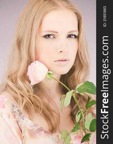 Portrait of young girl that holds delicate rose. Portrait of young girl that holds delicate rose
